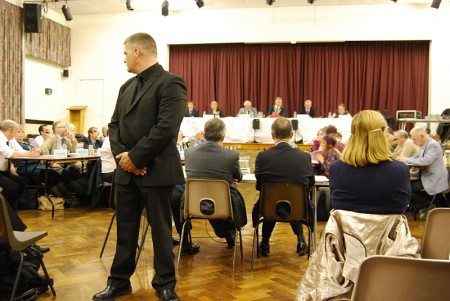 A security guard keeps watch at the Highwood Road council meeting.