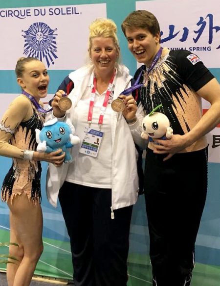 Acrogymnastics world championship bronze medalist winners Kenedi Cross (left) and Vada Finniear (right), with coach Sarah Bateman.