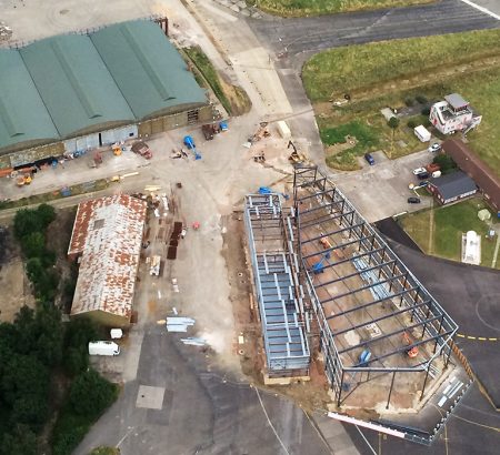 An aerial shot of Aerospace Bristol. This photo shows WWI grade II listed hangar 16S in the top left and the steelwork of the new Concorde hangar under construction.